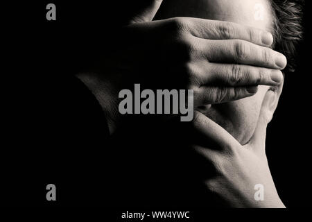Avoidance, man covering his face. Stock Photo