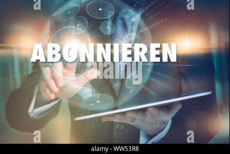 A hand selecting a Subscribe "Abonnieren" business concept in German on a futuristic computer display. Stock Photo