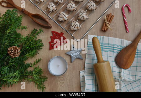 Christmas flat lay with pine, cookies, rolling pin, spoon and Christmas elements on a wooden background Stock Photo