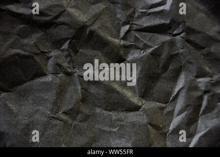 Crumpled black paper texture. Contrast abstract background Stock Photo