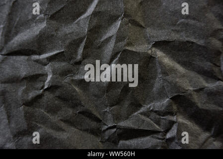 Crumpled black paper texture. Contrast abstract background Stock Photo