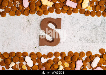 Dutch holiday Sinterklaas. Background with traditional food - pepernoten, chocolate letter, sweets strooigoed and carrots for horse. Concept for child Stock Photo