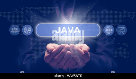 Businessmans cupped hands holding a Java business concept on a computerised display. Stock Photo