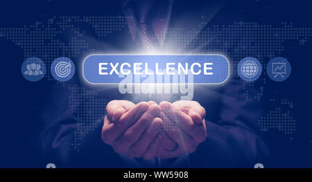 Businessmans cupped hands holding an Excellence business concept on a computerised display. Stock Photo