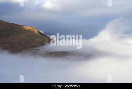 Cloud inversion over Patterdale with Arnison Crag to the left in the Lake District. Stock Photo