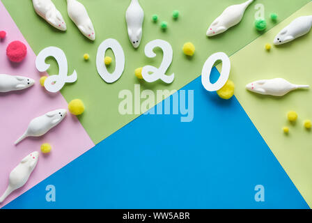 Happy New Year 2020, year of the mouse! Flat lay, top view of sweet white mice made from marshmallow with soft balls. Objects arranged on geometric pa Stock Photo