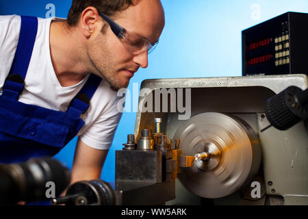 Close up of technician working on lathe machine. Stock Photo