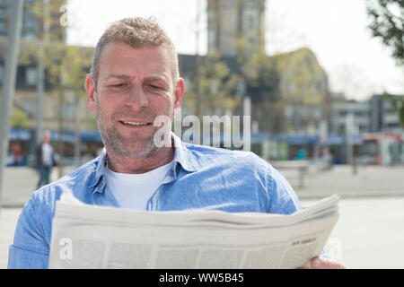 Man, reading newspaper Stock Photo