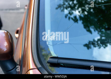 Broken car windshield glass from stone. Damaged windscreen on vehicle, close up Stock Photo