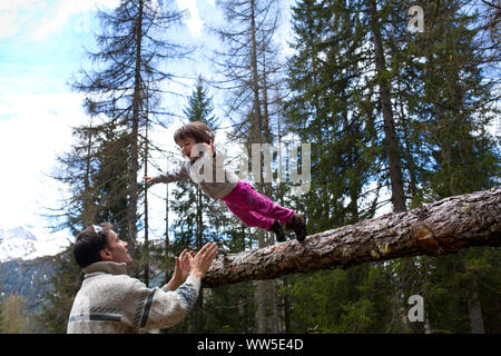 30-40 years old father catching 3-6 years old jumping daughter Stock Photo