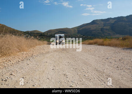 Saab with caravan driving on stony street in remote area Stock Photo