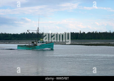 Commercial fishing boat returning to the harbor Stock Photo