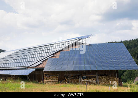 Solar PV panels producing sustainable electricity on a shed in Bavaria, Germany Stock Photo