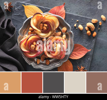 Color matching palette from picture of puff pastries with rose shaped apple slices on metal plate. Top lay on wooden board with Autumn leaves Stock Photo