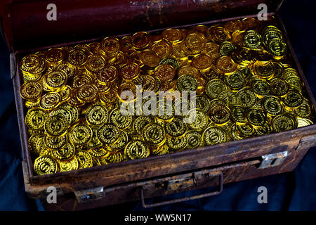 Stacking Gold Coin in treasure chest  old on black background Stock Photo
