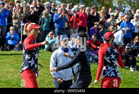 Team Europe's Celine Boutier (second left) and Georgia Hall (second right) console Team USA's Lexi Thompson (left) and Brittany Altomare after the Foursomes match on day one of the 2019 Solheim Cup at Gleneagles Golf Club, Auchterarder. Stock Photo