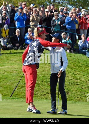 Team Europe's Celine Boutier (right) consoles Team USA's Lexi Thompson on the 17th after the Foursomes match on day one of the 2019 Solheim Cup at Gleneagles Golf Club, Auchterarder. Stock Photo