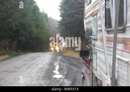 Logging truck (long timber transporter) with trunks on a Logging Road, near Cape Scott Provincial Park, British Columbia, Canada Stock Photo