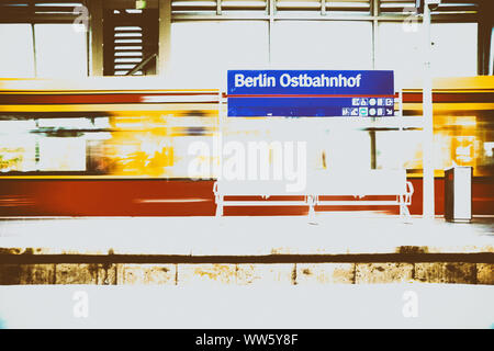 A platform of the Berlin Ostbahnhof with a grid bench and an incoming streetcar in Berlin. Stock Photo