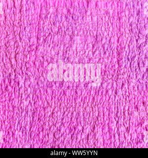 textile square background - wrinkled surface of scarf stitched from crushed pink cotton fabric Stock Photo