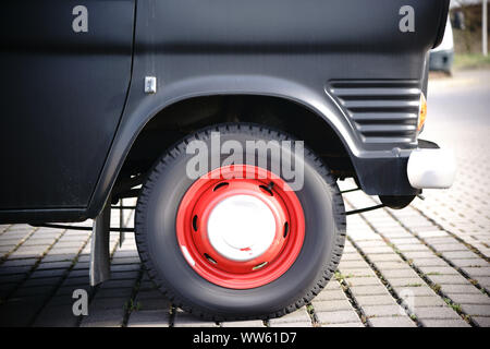 The side view and close-up of the front tyre of an old Ford caravan, Stock Photo