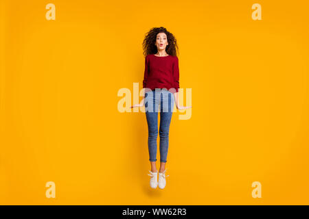 Full length body size view of nice lovely pretty attractive cheerful girlish feminine slim thin fit wavy-haired lady jumping up in air isolated on Stock Photo
