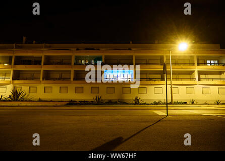 Christmas decoration with chain of lights on balcony, at night Stock Photo