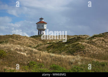 View above the dunes to the old water tower, the landmark of the island Langeoog. Stock Photo