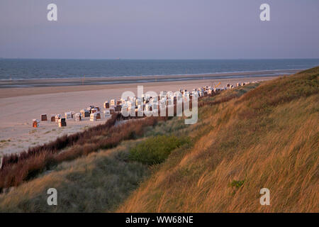 Main beach with beach chairs on the island Spiekeroog in the evening light. Stock Photo