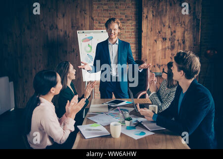 Close up photo business people he him his she her partners charts on table office together income earnings money clapping boss great training course Stock Photo