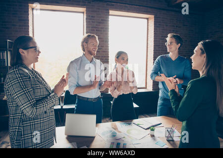 Close up photo stand around table business people she her he him his ovation development finance investment happy glad clap hands arms dressed Stock Photo