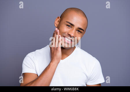 Close up photo glad dark skin he him his macho expertising checking skin after shaving hand arm cheek excited amazed with results wearing white t Stock Photo