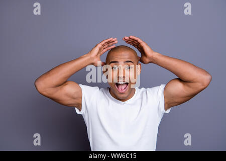 Close up photo strong healthy dark skin he him his macho bald head mouth opened yell with all voice hands arms raised wondered wearing white t-shirt Stock Photo