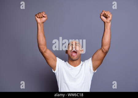 Close up photo strong healthy dark skin he him his macho bald head mouth opened yell with all voice football match hands arms raised wearing white t Stock Photo