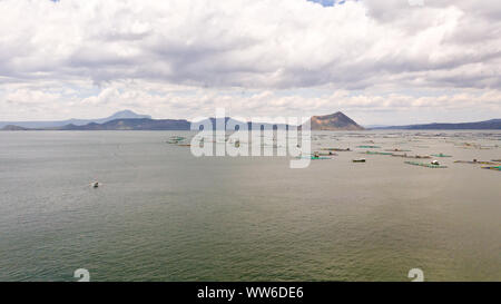 Lake Taal with a volcano and fish cages on a fish farm, top view. Luzon, Philippines Tropical landscape, mountains and volcano in the lake. Stock Photo