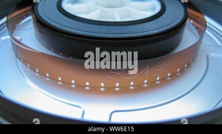 Roll of developed Super 16mm Film Negative on a Bobby in a can. 16mm Film is a popular and economical gauge of film stock.
