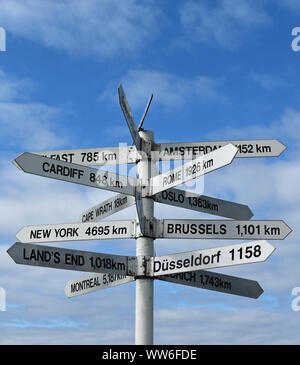 Fun signpost on North Coast 500 Scotland with signs and distances to places all over the world Stock Photo