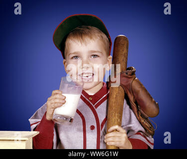 1960s SMILING BOY LOOKING AT CAMERA WEARING BASEBALL UNIFORM DRINKING MILK HOLDING BAT AND GLOVE - kf2941 HAR001 HARS FACIAL HEALTHY ATHLETE PLEASED JOY LIFESTYLE SATISFACTION STUDIO SHOT HEALTHINESS COPY SPACE HALF-LENGTH MALES ATHLETIC CONFIDENCE EXPRESSIONS EYE CONTACT HAPPINESS CHEERFUL LITTLE LEAGUE AND RECREATION PRIDE OF SMILES BASEBALL GLOVE JOYFUL BALL GAME BALL SPORT GROWTH JUVENILES BASEBALL BAT CAUCASIAN ETHNICITY HAR001 OLD FASHIONED Stock Photo