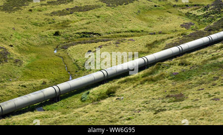 Hydroelectric water pipeline in beautiful green valley, Scottish Highlands Stock Photo