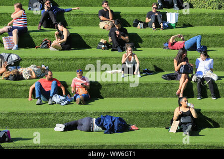London, UK, 13th Sep 2019. An early autumn mini heat wave with warm sunshine brings out sunbathers by the Regent's Canal at Granary Square near King's Cross in London this afternoon. Credit: Imageplotter/Alamy Live News Stock Photo
