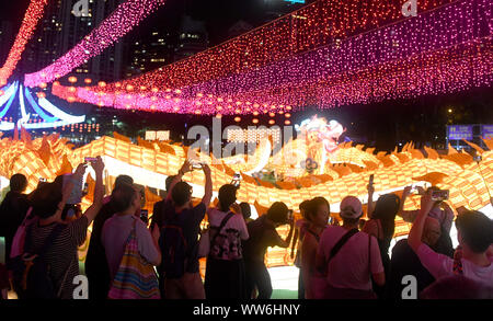 Hong Kong, China. 13th Sep, 2019. People view lanterns at a lantern fair celebrating the Mid-Autumn Festival at Victoria Park in Hong Kong, south China, Sept. 13, 2019. Credit: Lu Hanxin/Xinhua/Alamy Live News Stock Photo