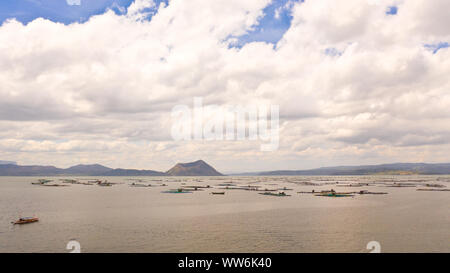 Lake Taal with a volcano and fish cages on a fish farm, top view. Luzon, Philippines Tropical landscape, mountains and volcano in the lake. Stock Photo