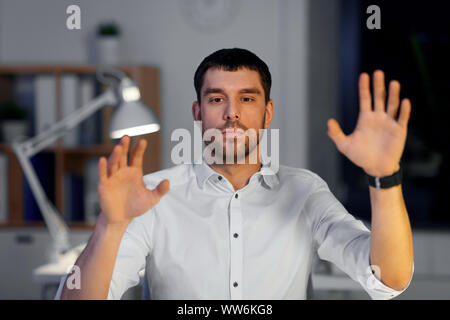 businessman using gestures at night office Stock Photo