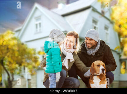 happy family with dog over house in autumn Stock Photo