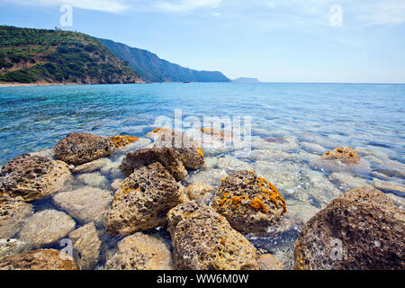 Boulders with holes of yellow drill sponge in Greece Stock Photo