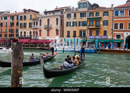 Gondolas on the Grand Canal in front of waterfront in Venice Stock Photo