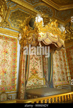 Paris / France - July 6, 2019: Gigantic bed in Queen Marie Antoinette room at Versailles Palace Stock Photo