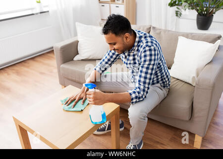 Man cleaning table Stock Photo by ©belchonock 105176182