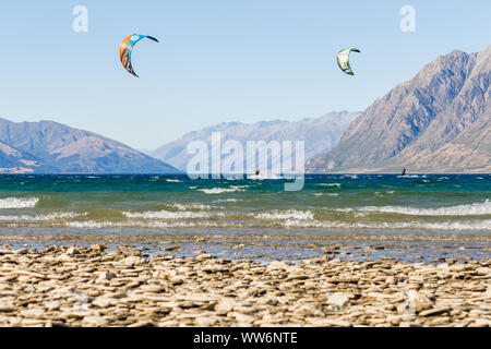 Kitesurfer in front of beautiful mountain scenery at lake hawea in New Zealand south island Stock Photo