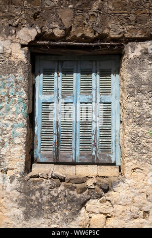 weathered closed shutters in Greece Stock Photo